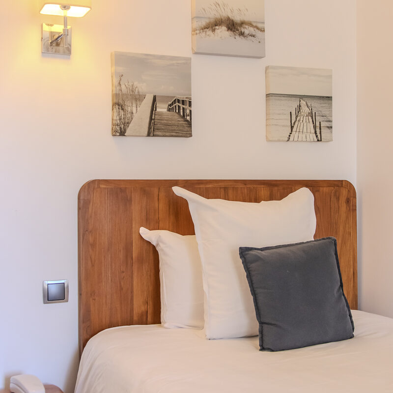 Chambre Single Rez-de-jardin : lit et tête de lit en bois, Manoir de Sauvegrain